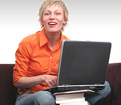 Woman sitting with laptop.